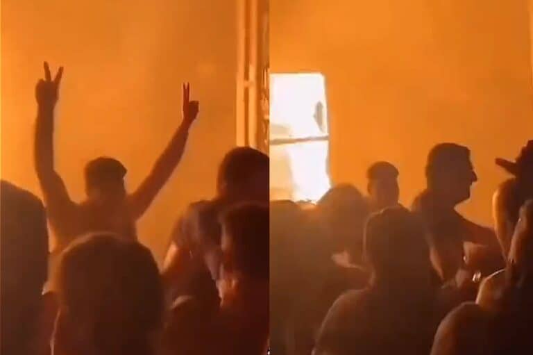 شاب يرفع شارة النصر خلال حريق قاعة أفراح الحمدانية في العراق