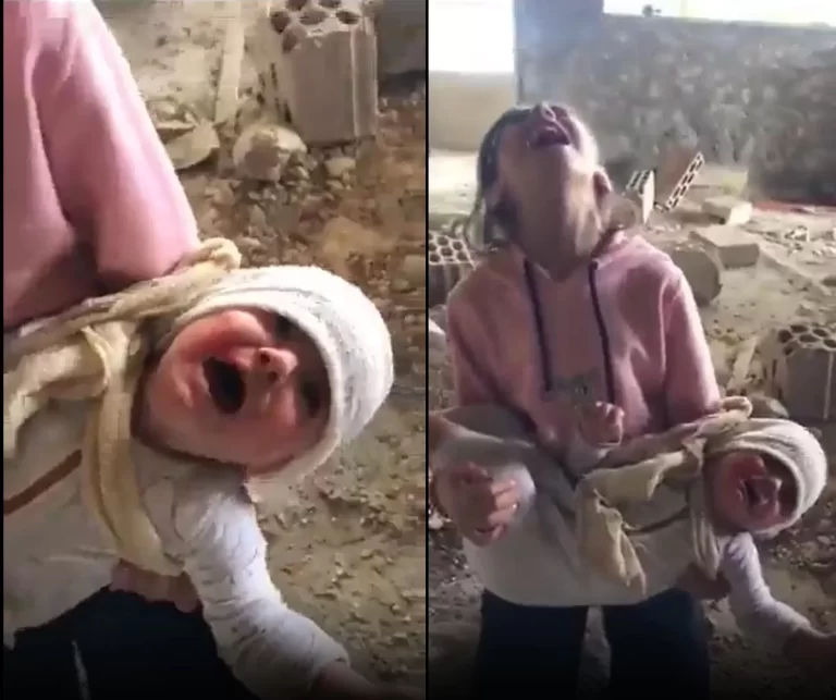طفلة فلسطينية تحمل شقيقها الصغير وتصرخ بعد ارتقاء جميع أفراد عائلتها في قصف إسرائيلي